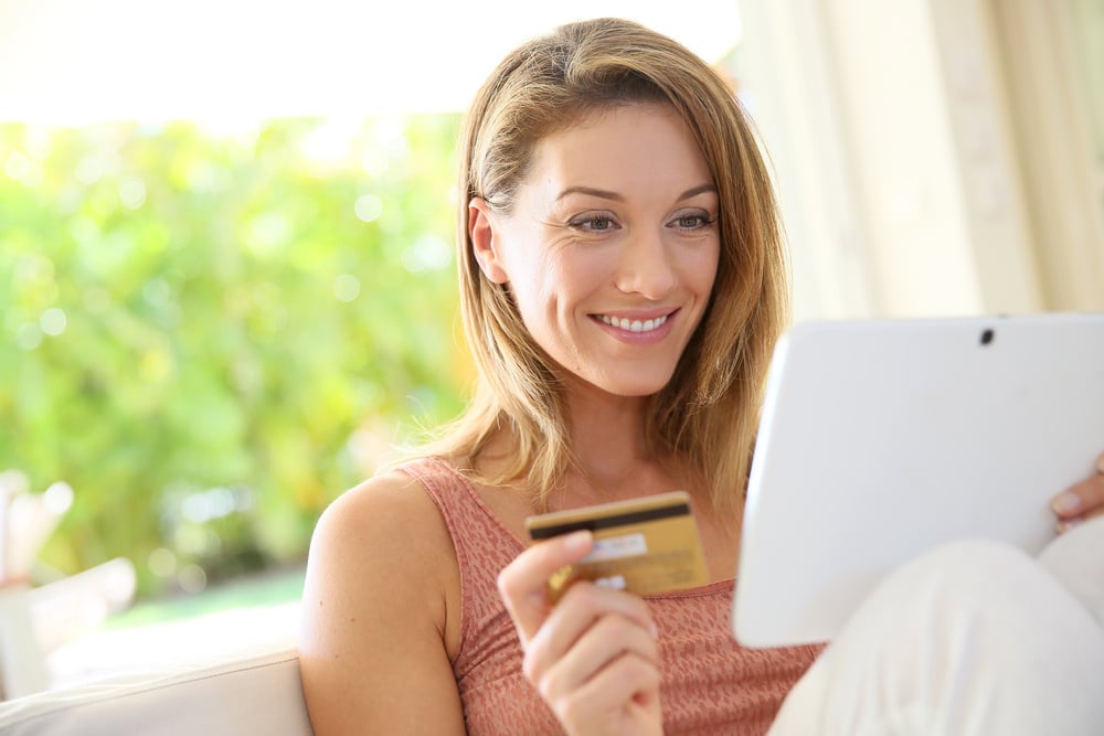 Portrait of woman shopping on internet with tablet